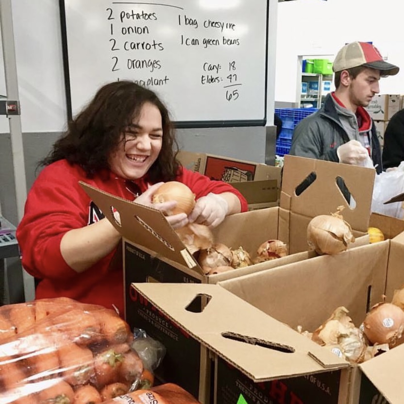 Students assist in packing grocery bags for low income elderly in the triangle area.