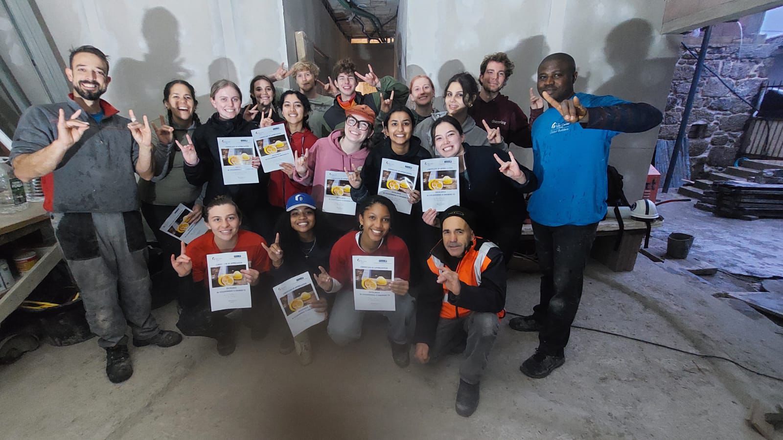 Students posing for a picture with Fuller Center staff.